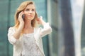 Young businesswoman talking on cellphone while walking outdoor Royalty Free Stock Photo