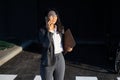 Young businesswoman talking on the phone and holding a laptop in her hands Royalty Free Stock Photo