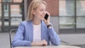 Young Businesswoman Talking on Phone Sitting Outdoor Royalty Free Stock Photo