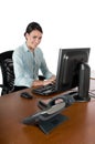 Young businesswoman typing at computer, isolated