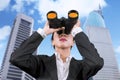 Young businesswoman using binoculars at outdoors Royalty Free Stock Photo
