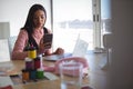 Young businesswoman using mobile phone at office desk Royalty Free Stock Photo