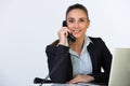 Young businesswoman using phone in office Royalty Free Stock Photo