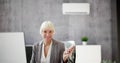 Young Businesswoman Using Air Conditioner Royalty Free Stock Photo