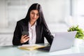 Young businesswoman using smart mobile phone and laptop computer with screen blank on desk, Young woman use device internet for Royalty Free Stock Photo