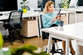 Young businesswoman using smartphone at workplace with coffee Royalty Free Stock Photo