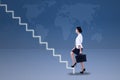 Young businesswoman walking up on stairs