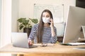 Young businesswoman wearing face mask while working on laptop Royalty Free Stock Photo