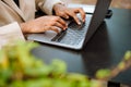 Young businesswoman wearing suit using laptop while sitting outdoors Royalty Free Stock Photo