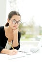 Young businesswoman working in a bright office Royalty Free Stock Photo