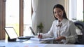 Young businesswoman working with computer tablet at bright office. Royalty Free Stock Photo