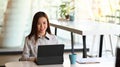 A young businesswoman working or using computer tablet searching information online in office. Royalty Free Stock Photo