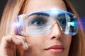 Young businesswoman working in virtual glasses, select the icon software testing on the virtual display Royalty Free Stock Photo