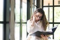 Young businesswoman at workplace and reading paper in office. business woman wearing suit holding documents in hand Royalty Free Stock Photo