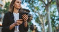 Young  businesswoman writes messages on smartphone while walking in a Barcelona Park on Sunny day, professional financier girl Royalty Free Stock Photo