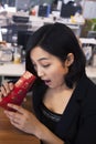 Young businesswomen looking into traditional red envelopment, Chinese New Year