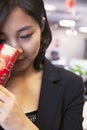 Young businesswomen looking into traditional red envelopment, Chinese New Year