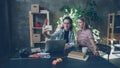 Young businesswomen are making selfie together in modern office while sitting at desk. They are posing with funny faces Royalty Free Stock Photo