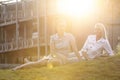 Young businesswomen relaxing on office lawn