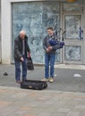 A Young Busker playing the bagpipes to an appreciative audience in the High Street of Perth.