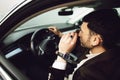 Young bussinesman in suit and black glasses driving his car. Bussines look. Test drive of the new car Royalty Free Stock Photo