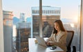 Young busy Asian business woman executive working on laptop in corporate office. Royalty Free Stock Photo