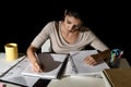 Young busy beautiful Spanish girl studying at home late night looking preparing exam concentrated Royalty Free Stock Photo