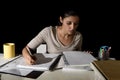 Young busy beautiful Spanish girl studying at home late night looking preparing exam concentrated Royalty Free Stock Photo