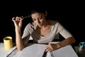 Young busy beautiful Spanish girl studying at home late night looking preparing exam concentrated Royalty Free Stock Photo