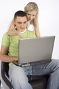 Young busy couple with laptop
