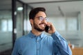 Young busy latin businessman talking on the phone in office. Royalty Free Stock Photo