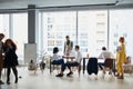 Young busy multiracial business people working together in coworking space Royalty Free Stock Photo