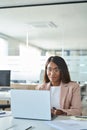 Young busy professional business woman working on laptop in office.