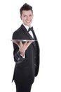 Young butler or waiter in black suit isolated on white