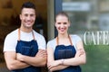 Young cafe owners in doorway Royalty Free Stock Photo