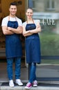 Young cafe owners in doorway Royalty Free Stock Photo