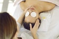 Young calm female client enjoys relaxing face and head massage in spa or in beautician& x27;s office. Royalty Free Stock Photo