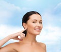 Young calm woman pointing to her ear Royalty Free Stock Photo