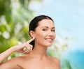 Young calm woman pointing to her ear Royalty Free Stock Photo