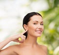 Young calm woman pointing to her ear Royalty Free Stock Photo