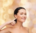 Young calm woman pointing to her ear Royalty Free Stock Photo