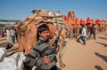 Young cameleer keeps a tight rein on camel Royalty Free Stock Photo