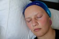 Portrait of a young cancer patient in a headscarf sleeping in bed Royalty Free Stock Photo