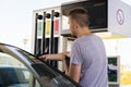 Young car driver man in casual on fuel station near gas pump Royalty Free Stock Photo