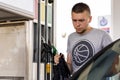 Young car driver man in casual on fuel station near gas pump Royalty Free Stock Photo