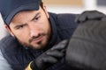 young car mechanic inspecting tyre Royalty Free Stock Photo