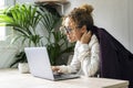 Young carefree adult manager woman working on laptop at office. Professional businesswoman using computer indoor in home workplace Royalty Free Stock Photo