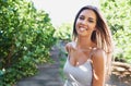 Young and carefree. A beautiful young woman standing outdoors in summer. Royalty Free Stock Photo