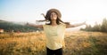 Young carefree woman enjoying nature and sunlight in straw hat Royalty Free Stock Photo