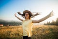 Young carefree woman enjoying nature and sunlight in straw hat Royalty Free Stock Photo